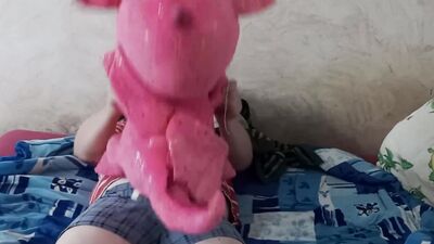 Lad rubs his hard wily on a cute pinky dinosaur