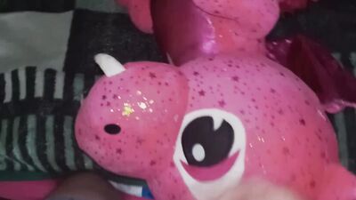 Fella rubs his johnson on a pinky dinosaur inside the bedroom