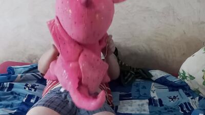 Fella rubs his johnson on a pinky dinosaur inside the bedroom