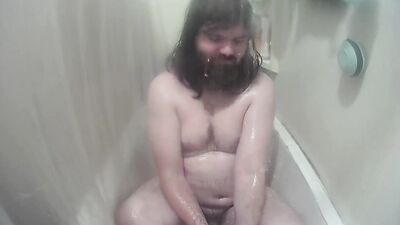 Longhaired chubby fellow is jerking his prick inside the hot shower