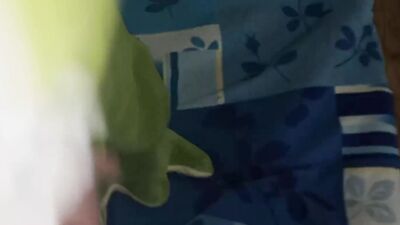 Perverted bloke is rubbing his pecker on a green toy