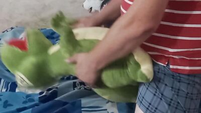 Perverted bloke is rubbing his pecker on a green toy