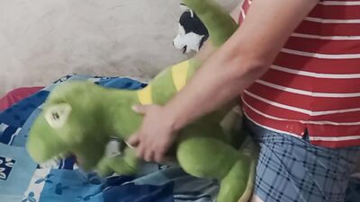 Perverted bloke is rubbing his pecker on a green toy