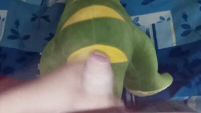 Perverted bloke is rubbing his pecker on a green toy