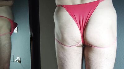 Perverted femboy plays with a cock in front of the mirror