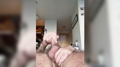 Bearded bloke is playing with a prick in front of the cam