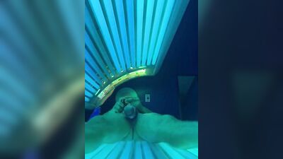 Horny bloke is jerking his cock inside the tanning salon