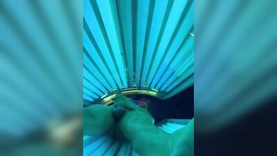 Horny bloke is jerking his cock inside the tanning salon