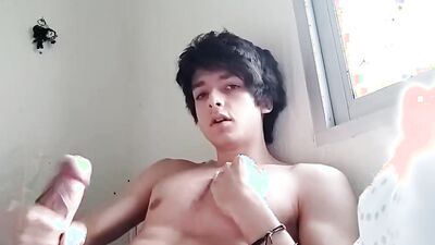Good looking teen jerks his prick in front of the cam
