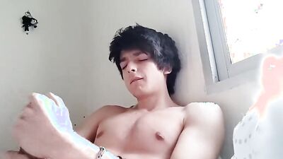 Good looking teen jerks his prick in front of the cam