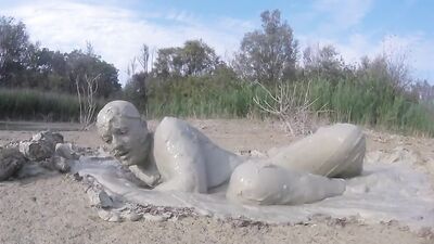 Perverted bloke is having fun out in the open inside the mud
