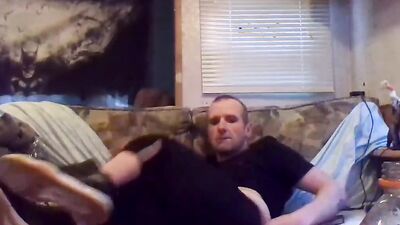 Perverted amateur bloke is stroking his tiny pecker on the couch