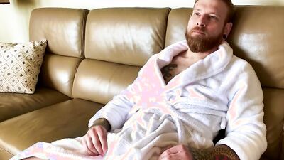 Horny bearded bloke is stroking his hard prick after the shower