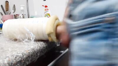 Lad plays with a plastic puss inside the public restroom