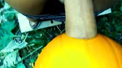 Amateur twink is shoving his hard prick into a pumpkin