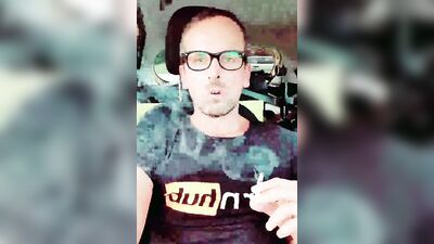 Horny dudes strokes his dick inside the car while smoking a cigarette