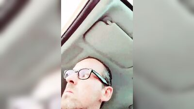 Horny dudes strokes his dick inside the car while smoking a cigarette