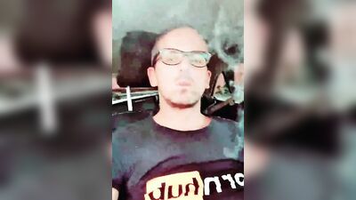 Horny dudes strokes his dick inside the car while smoking a cigarette