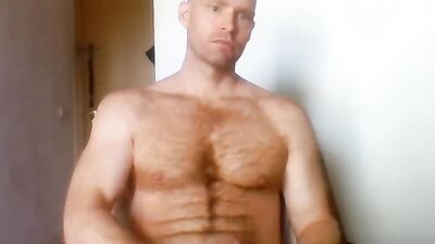 Beefed chap is stroking his cock in this solo performance
