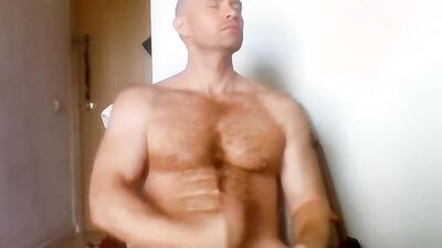 Beefed chap is stroking his cock in this solo performance