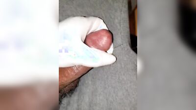 Close-up video of a chap stroking his prick while wearing a gloves
