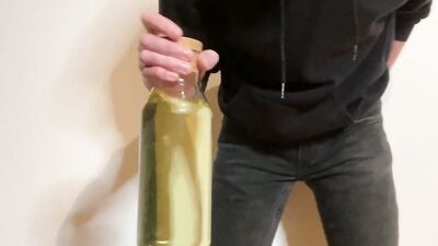 Chap pees in the bottle in this amateur solo video