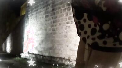 Old tranny is walking across the city and posing for the camera