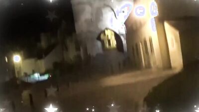 Old tranny is walking across the city and posing for the camera