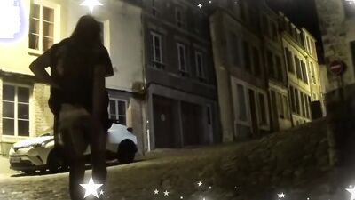 Old tranny is walking across the city and posing for the camera