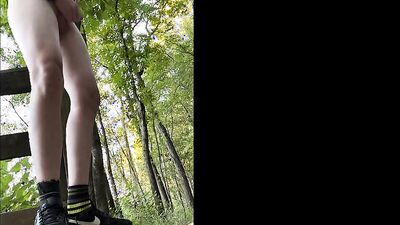 Round ass femboy is flashing his cheeks out in the forest