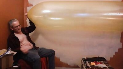 Perverted stepdad plays with huge balloon in front of the camera