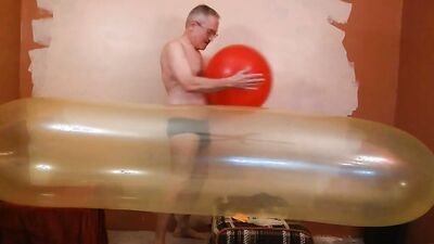 Perverted stepdad plays with huge balloon in front of the camera