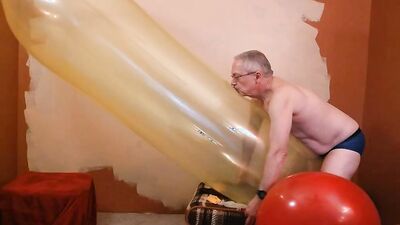 Perverted stepdad plays with huge balloon in front of the camera