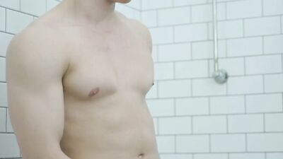 Handsome straight bloke is playing with a cock inside the bathroom