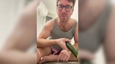 Perverted chap is shoving a cucumber deep down his tight hole