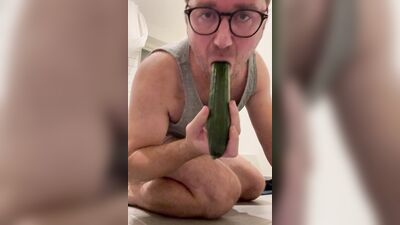 Perverted chap is shoving a cucumber deep down his tight hole