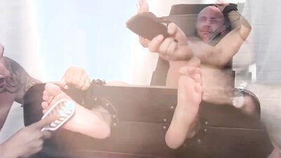 Handsome tied up bloke gets teased by his two horny buds