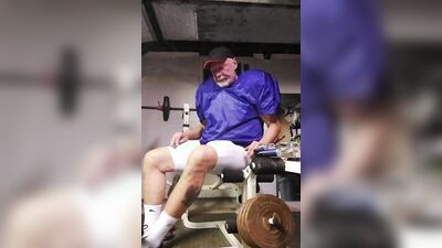 Football practice uniform and coach relaxing after team leaves