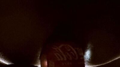 Close-up video of a bloke shoving coca cola bottle into his ass