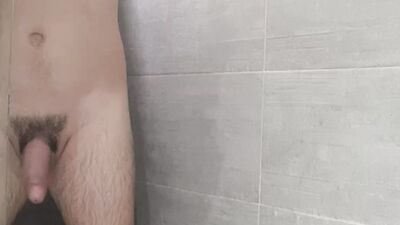 Amateur bloke is shaving his pubic hairs while taking a shower