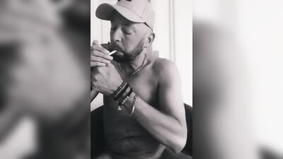 Amateur chap plays with his genitals while smoking a cigarette