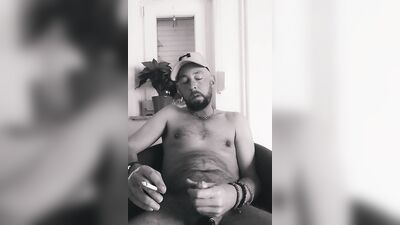 Amateur chap plays with his genitals while smoking a cigarette