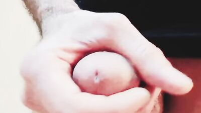 Close-up clip of a dude stroking hisnhard wood