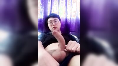 Cute Asian chap plays with his doll in front of the cam