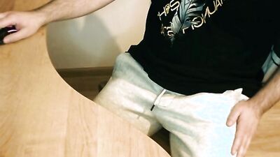 Perverted chap is jerking his hard pecker at the table