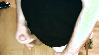 Perverted chap is jerking his hard pecker at the table