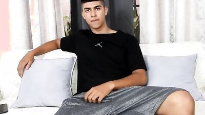 Cute Latino is stroking his hard prick on the couch