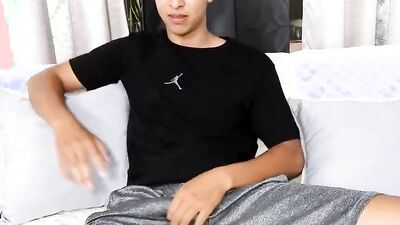 Cute Latino is stroking his hard prick on the couch