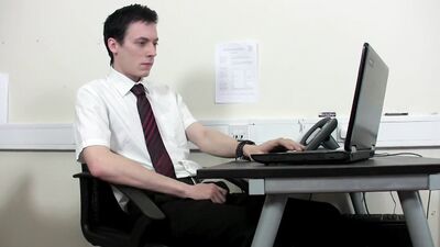 Dressed up bloke is jerking his prick inside the office