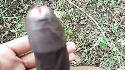Amateur lad strokes his hard pecker out in the open